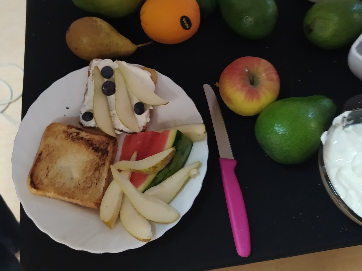 Prepared plate with fruits and bread.